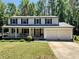 Charming two-story home with a covered front porch, two-car garage, and well-maintained lawn at 2691 Old South Dr, Jonesboro, GA 30236
