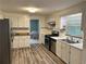 Well-equipped kitchen featuring stainless steel appliances, white cabinets, and stylish flooring at 2691 Old South Dr, Jonesboro, GA 30236