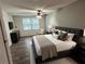 Spacious primary bedroom with a ceiling fan, sleek furniture, and plenty of natural light at 2691 Old South Dr, Jonesboro, GA 30236