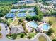 An aerial view showcasing the community's tennis courts, pools, clubhouse, and lush landscaping at 3150 Seven Oaks Dr, Cumming, GA 30041