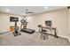 Spacious carpeted basement featuring workout equipment, a desk, and neutral-toned walls, creating a versatile area at 3150 Seven Oaks Dr, Cumming, GA 30041