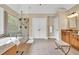 Bright bathroom featuring a glass door shower, soaking tub, and wood vanity at 3150 Seven Oaks Dr, Cumming, GA 30041