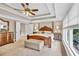 Spacious bedroom with carpet, tray ceilings, ceiling fan, and large windows at 3150 Seven Oaks Dr, Cumming, GA 30041