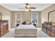 Inviting bedroom with neutral walls, carpet, ceiling fan, and two dressers at 3150 Seven Oaks Dr, Cumming, GA 30041