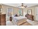 Comfortable bedroom with neutral walls, ceiling fan, and ample natural light from two large windows at 3150 Seven Oaks Dr, Cumming, GA 30041