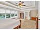 Spacious bedroom with carpet, tray ceilings, and large windows with view to outside at 3150 Seven Oaks Dr, Cumming, GA 30041