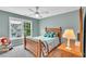 Bright bedroom with a large window, wooden furniture, and a cheerful atmosphere at 3150 Seven Oaks Dr, Cumming, GA 30041