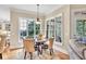 Cozy breakfast nook with natural light, round table with seating, and hardwood floors at 3150 Seven Oaks Dr, Cumming, GA 30041