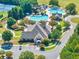 Aerial view featuring a clubhouse, swimming pool, tennis court and well-manicured lawns at 3150 Seven Oaks Dr, Cumming, GA 30041
