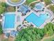 Aerial shot of a community pool featuring a slide, swimming area, lounge chairs, and well-kept grounds at 3150 Seven Oaks Dr, Cumming, GA 30041