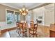 Dining room with hardwood floors, chandelier, and views into the office space at 3150 Seven Oaks Dr, Cumming, GA 30041