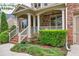 Inviting front porch with brick stairs, white railings, and lush green landscaping at 3150 Seven Oaks Dr, Cumming, GA 30041