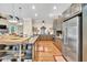 Modern kitchen featuring stainless steel appliances, granite counters, wooden floors, and pendant lighting at 3150 Seven Oaks Dr, Cumming, GA 30041
