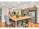 Kitchen featuring stainless appliances, granite counters, wooden floors, a built-in microwave and an island with barstool seating at 3150 Seven Oaks Dr, Cumming, GA 30041