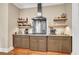 Kitchen area featuring stainless steel appliances, custom cabinetry, granite counters, wooden floors, and floating shelves at 3150 Seven Oaks Dr, Cumming, GA 30041