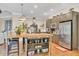 Spacious kitchen features a large island with seating and stainless steel appliances at 3150 Seven Oaks Dr, Cumming, GA 30041