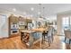 Kitchen featuring stainless appliances, granite counters, wooden floors, a built-in microwave and an island with barstool seating at 3150 Seven Oaks Dr, Cumming, GA 30041