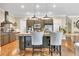 Kitchen area featuring stainless steel appliances, granite counters, wooden floors, and a butcher block island with seating at 3150 Seven Oaks Dr, Cumming, GA 30041