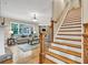 Inviting living room with stone fireplace, hardwood floors, and staircase access at 3150 Seven Oaks Dr, Cumming, GA 30041