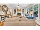 Inviting living room featuring a fireplace, custom built-ins, and large windows showcasing the outdoor views at 3150 Seven Oaks Dr, Cumming, GA 30041