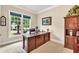 Well-lit home office featuring a large window, desk, and built-in shelving at 3150 Seven Oaks Dr, Cumming, GA 30041