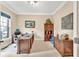 Well-lit home office with a large desk, wooden furniture, and neutral decor at 3150 Seven Oaks Dr, Cumming, GA 30041