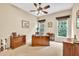 Spacious office with dual windows, a ceiling fan, and a large desk at 3150 Seven Oaks Dr, Cumming, GA 30041