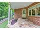 Stone patio with steps leading to the backyard, offering a cozy outdoor space with brick accents at 3150 Seven Oaks Dr, Cumming, GA 30041