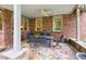 Outdoor patio with brick columns, stone flooring, ceiling fan and table with seating for eight at 3150 Seven Oaks Dr, Cumming, GA 30041