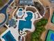 Overhead view of community pool, waterslides, landscaping and adjacent tennis courts at 3150 Seven Oaks Dr, Cumming, GA 30041