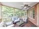 Relaxing screened porch with comfortable seating, ceiling fan, and views of the lush backyard at 3150 Seven Oaks Dr, Cumming, GA 30041