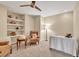 Well-lit sitting room featuring custom shelving and comfortable seating at 3150 Seven Oaks Dr, Cumming, GA 30041
