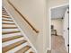 A stairway with carpet runner leads to an open door, providing access to more rooms at 3150 Seven Oaks Dr, Cumming, GA 30041