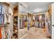Large walk-in closet featuring custom shelving, racks, and a full-length mirror at 3150 Seven Oaks Dr, Cumming, GA 30041
