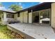 Outdoor patio with sliding glass doors and a view of the backyard and detached garage at 6873 Church St, Riverdale, GA 30274