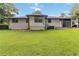Spacious backyard featuring a white brick home with a well-maintained lawn at 6873 Church St, Riverdale, GA 30274
