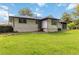Expansive backyard with lush green lawn and brick home at 6873 Church St, Riverdale, GA 30274