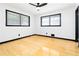 Bedroom featuring hard wood floors, neutral walls, ceiling fan, and two windows at 6873 Church St, Riverdale, GA 30274