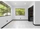 Bright bedroom featuring tile flooring, and closet with built-in shelving at 6873 Church St, Riverdale, GA 30274