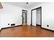 Bright bedroom featuring hardwood floors, neutral walls, and a closet at 6873 Church St, Riverdale, GA 30274
