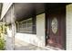 Covered front porch with decorative front door and white painted brick at 6873 Church St, Riverdale, GA 30274