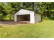 Detached one-car garage surrounded by a green, well-maintained lawn at 6873 Church St, Riverdale, GA 30274