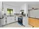 Bright white kitchen with stone countertops, white cabinets, and stainless steel appliances at 6873 Church St, Riverdale, GA 30274