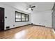 Spacious living room featuring hardwood floors, ceiling fan, and modern black accents at 6873 Church St, Riverdale, GA 30274