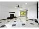 Large living room with fireplace, modern ceiling fan, and sliding glass door at 6873 Church St, Riverdale, GA 30274