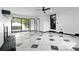 Bright and spacious living area with marble style flooring, ceiling fan, and large glass doors at 6873 Church St, Riverdale, GA 30274
