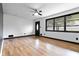 Bright living room with hardwood floors, fresh paint, and modern ceiling fan at 6873 Church St, Riverdale, GA 30274