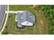 Aerial view of a modern home with well-manicured landscaping and a paved driveway at 130 Lapis Lake Pt, Fayetteville, GA 30215