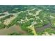 Community aerial view with lush green landscapes, lake, and recreational facilities at 130 Lapis Lake Pt, Fayetteville, GA 30215