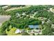 Aerial view of the community amenities with a pool, tennis courts, and surrounding greenery at 130 Lapis Lake Pt, Fayetteville, GA 30215